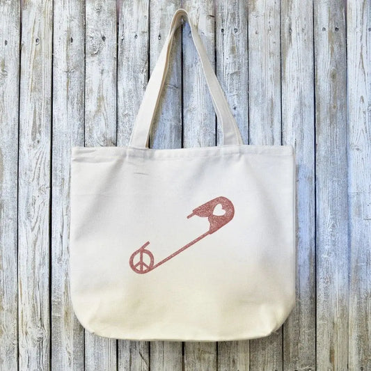 Eco-friendly Unity Gift Tote Bag made from organic canvas with artist-designed red safety pin graphic, perfect for sustainable daily carry.