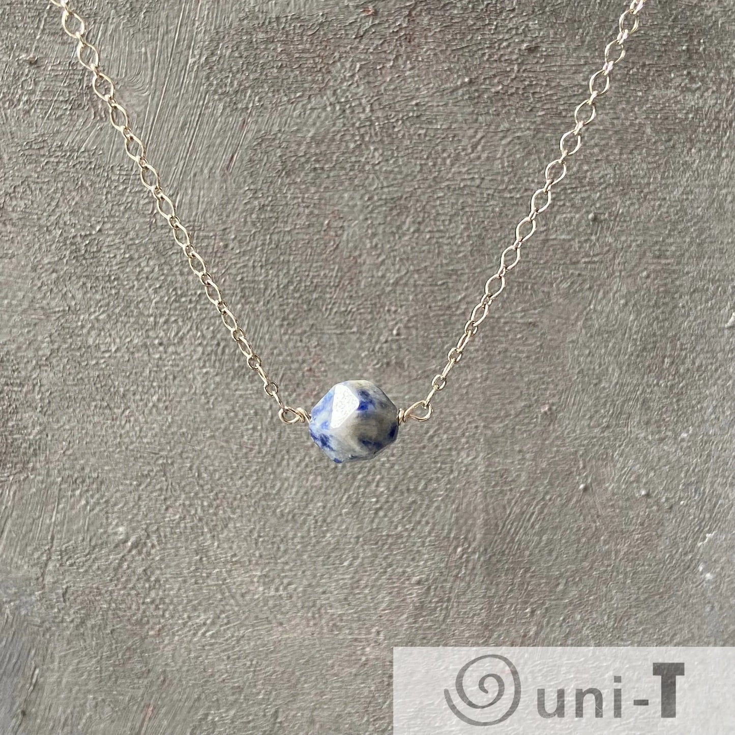 Minimalist Sodalite Gemstone Necklace by Uni-T with a single faceted blue stone on a delicate silver chain, elegant for everyday wear.