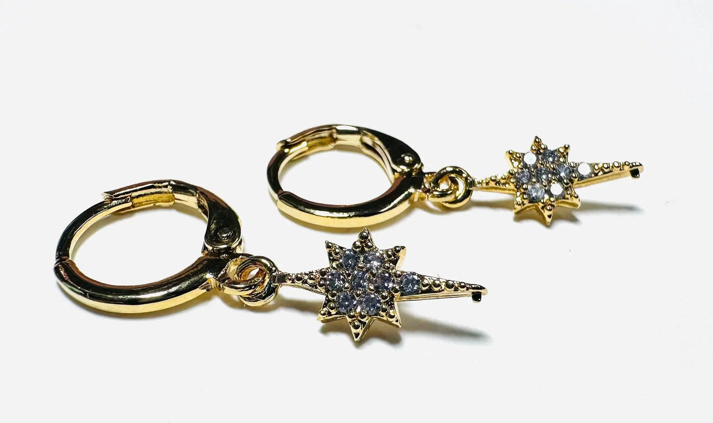 Gold Star Huggie Hoops with cubic zirconia detailing, ideal for celestial-themed fashion and everyday sparkle.