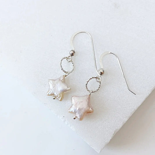 Freshwater pearl star earrings in white with sterling silver twisted loop design. Lightweight and stylish for everyday elegance.