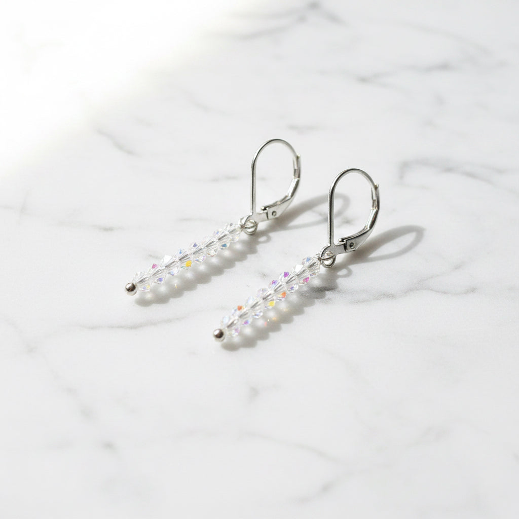 Side view of Glitter Stixx Gemstone Earrings showing clear faceted beads and silver hardware, ideal for adding subtle shimmer to outfits.
