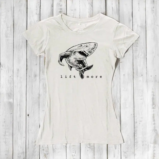 Natural white bamboo and organic cotton women's T-shirt featuring a shark and 'Lift More' text. Sustainable workout wear for lifters.