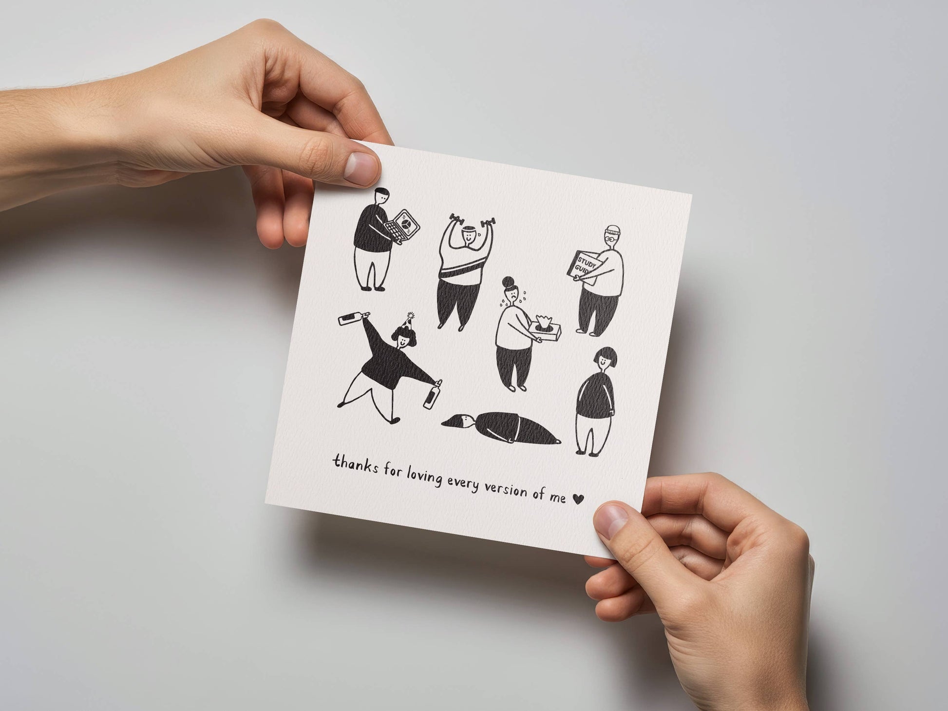 Person holding a monochrome greeting card with fun illustrations and heartfelt message