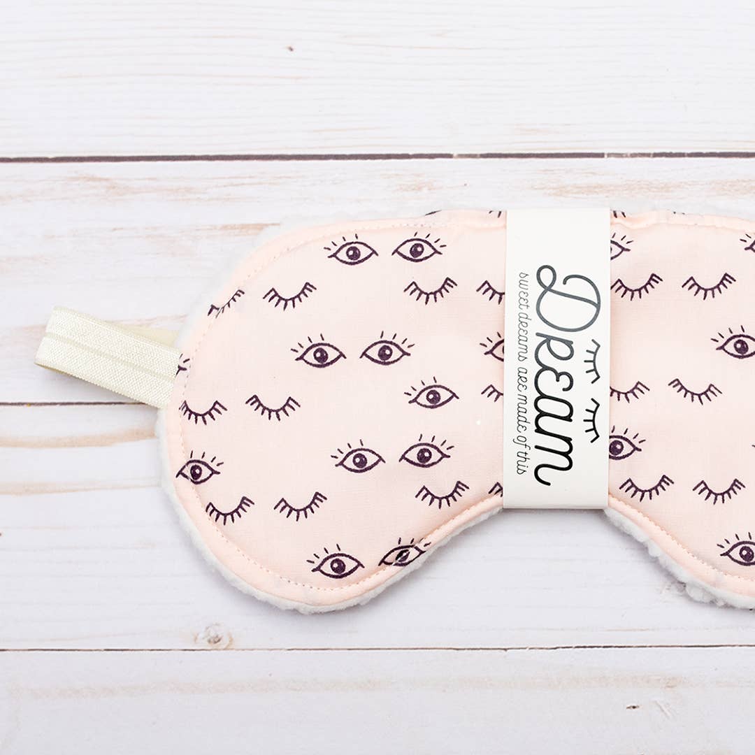 Front view of Wink Sweet Dreams Cotton Sleep Mask featuring whimsical eye print and soft cotton texture, perfect for bedtime relaxation.