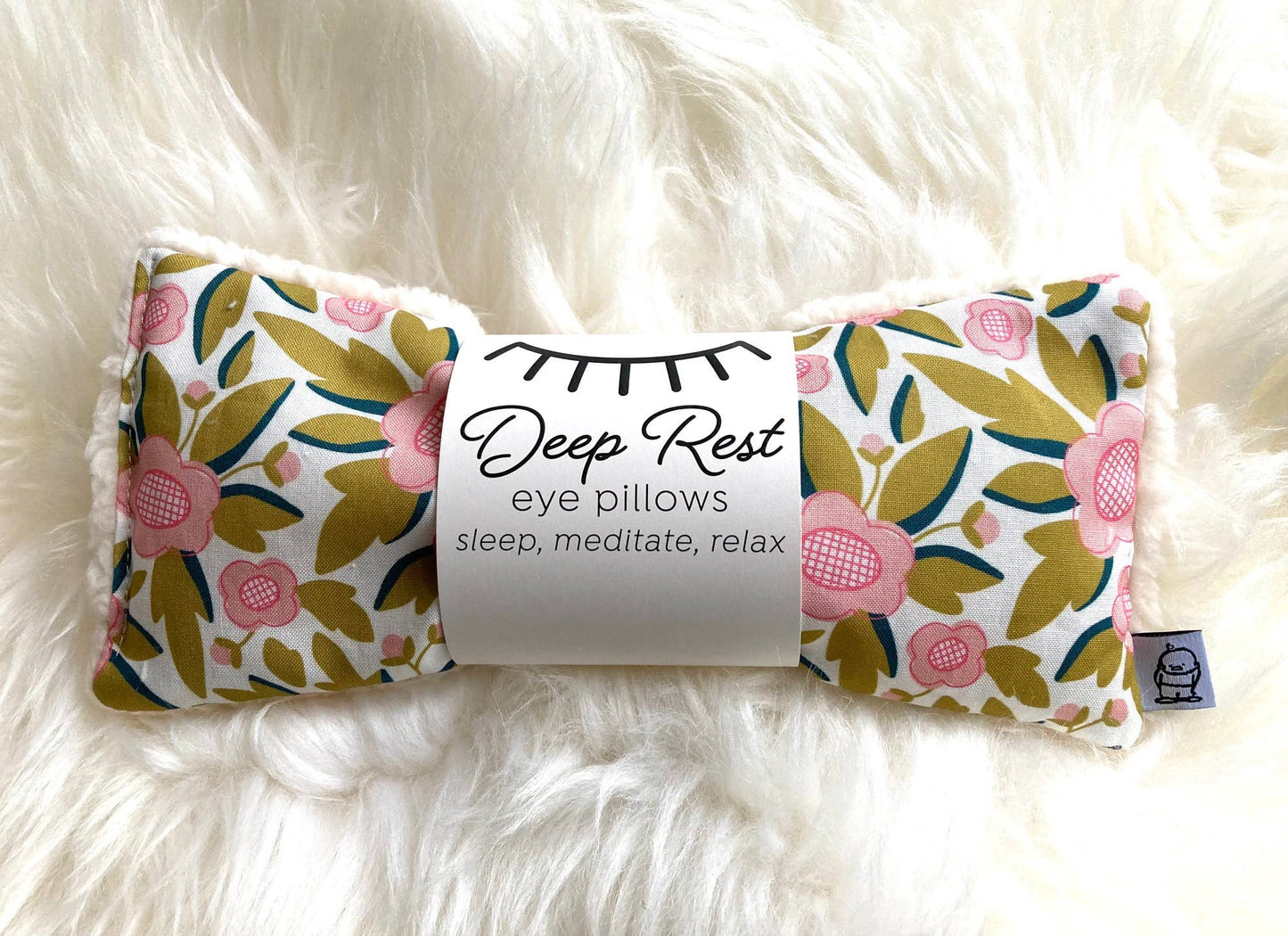 Weighted eye pillow for relaxation in garden floral print with Deep Rest label, ideal for stress relief and meditation use.