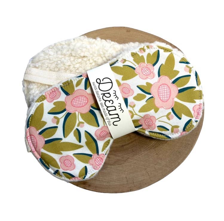 Sweet Dreams Cotton Sleep Mask with pink floral print and cream minky backing, displayed on a wooden tray for relaxation aid.