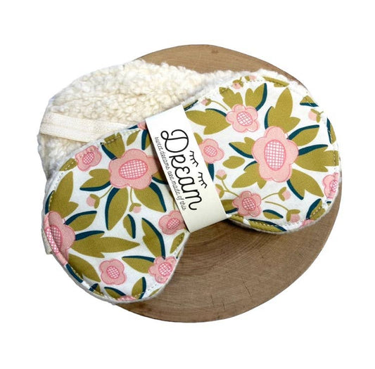 Sweet Dreams Cotton Sleep Mask with pink floral print and cream minky backing, displayed on a wooden tray for relaxation aid.