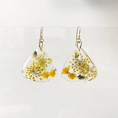 Triangle resin earrings with yellow floral inclusions and gold hooks. Elegant design from Real Flower Earrings - UNI-T.