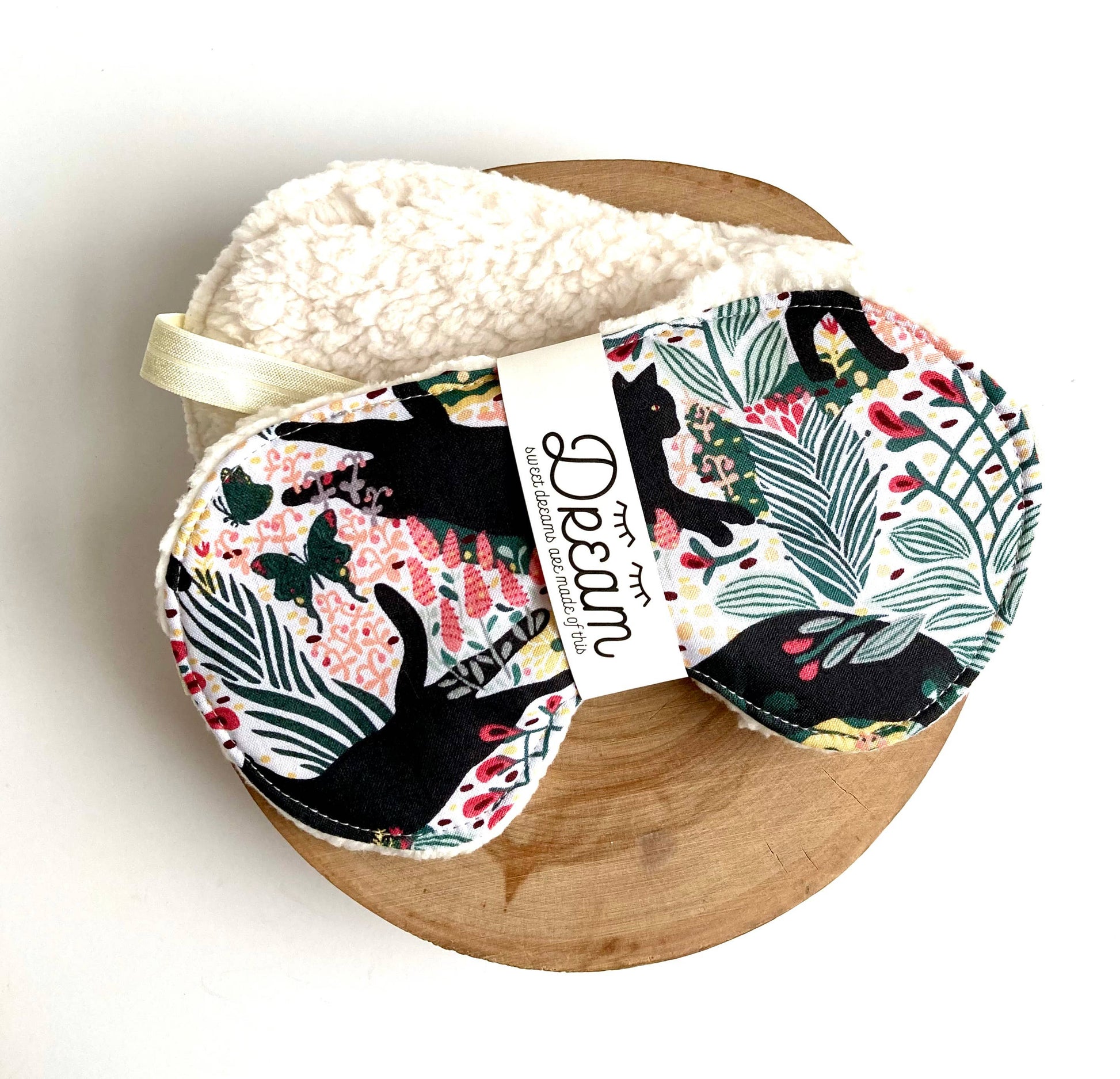 Jungle Cat Sleep Mask with cotton front and soft minky lining, featuring black cat and floral print for relaxation and sleep aid.