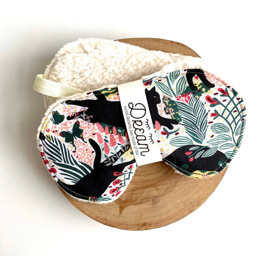 Jungle Cat Sleep Mask with cotton front and soft minky lining, featuring black cat and floral print for relaxation and sleep aid.