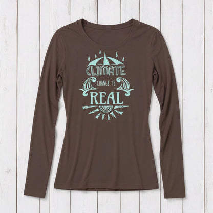 Brown long sleeve T-shirt with a light blue graphic design featuring an umbrella, waves, and the phrase 'Climate Change is Real' on a white wooden background