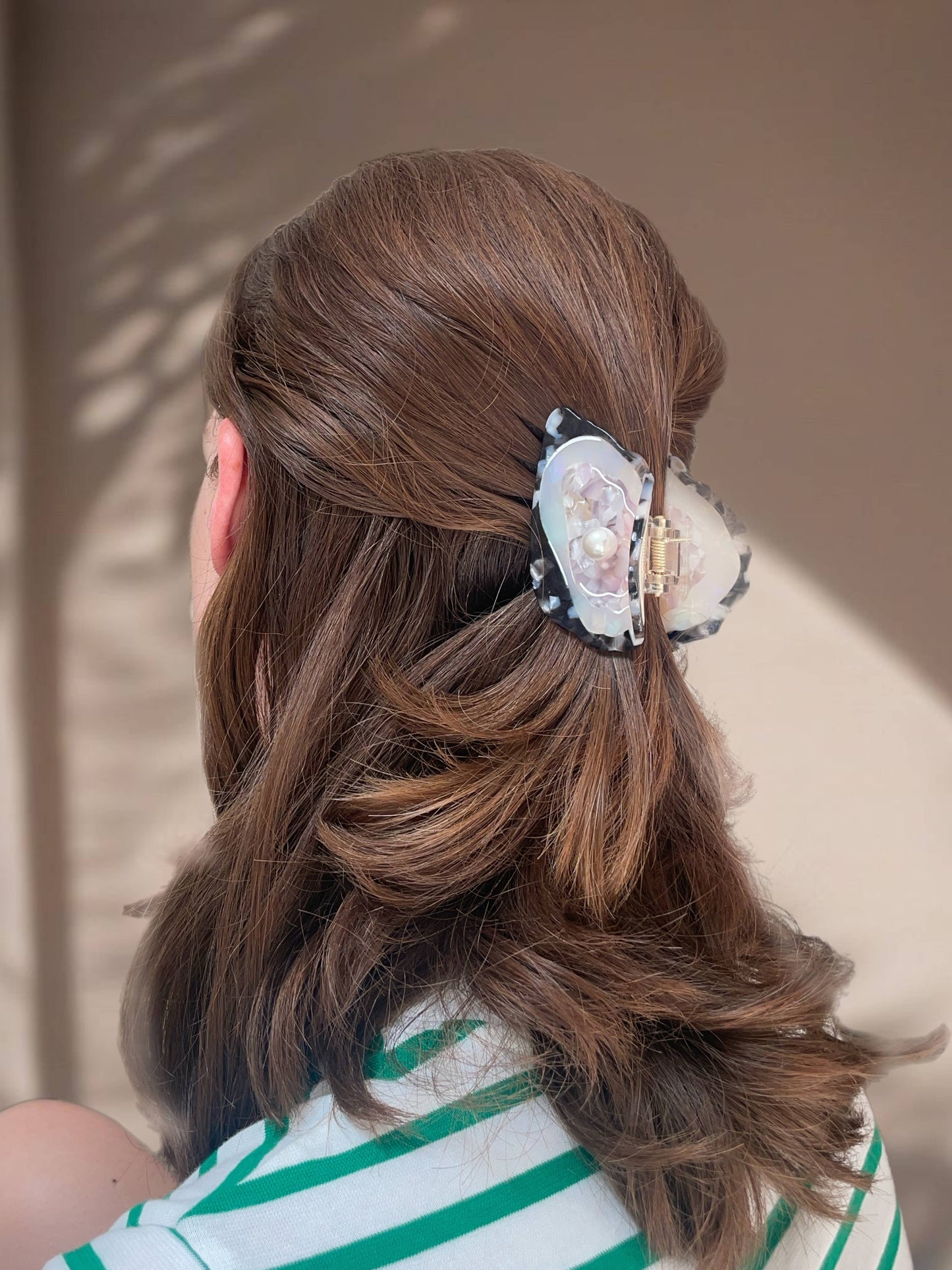 Back view of model with Line&Co Oyster Claw Clip with Pearl securing a twisted hairstyle. Ideal for casual or elegant occasions.