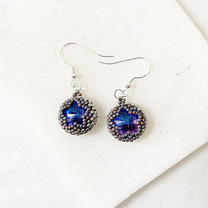 Detailed view of beaded crystal earrings with silver hooks and shimmering blue stones, part of a coordinated jewelry set.