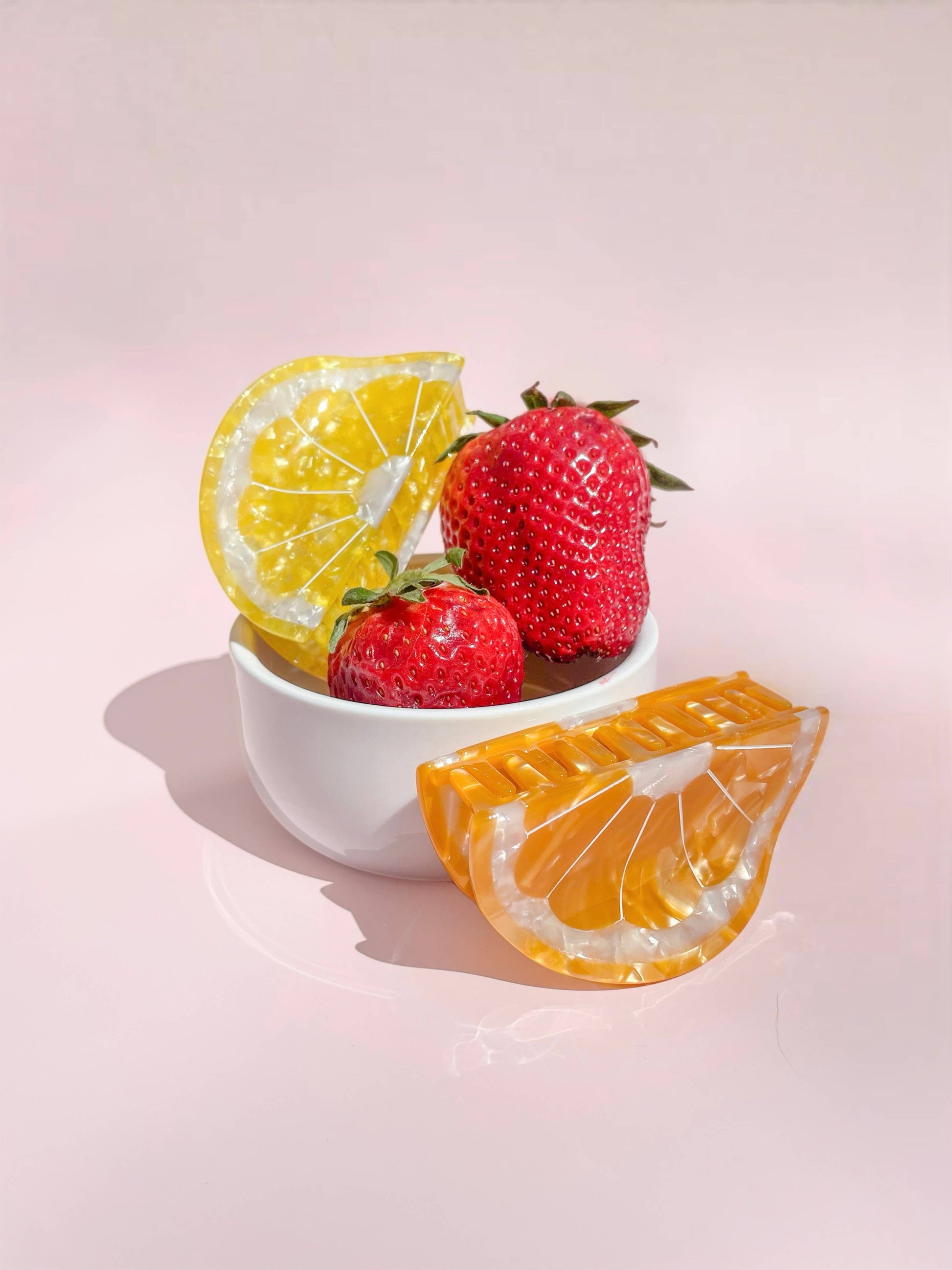 Sunshine Yellow Lemon Claw Hair Clip styled with strawberries in a bowl, showcasing its fruity charm and seasonal accessory appeal.