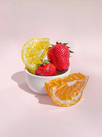 Sunshine Yellow Lemon Claw Hair Clip styled with strawberries in a bowl, showcasing its fruity charm and seasonal accessory appeal.