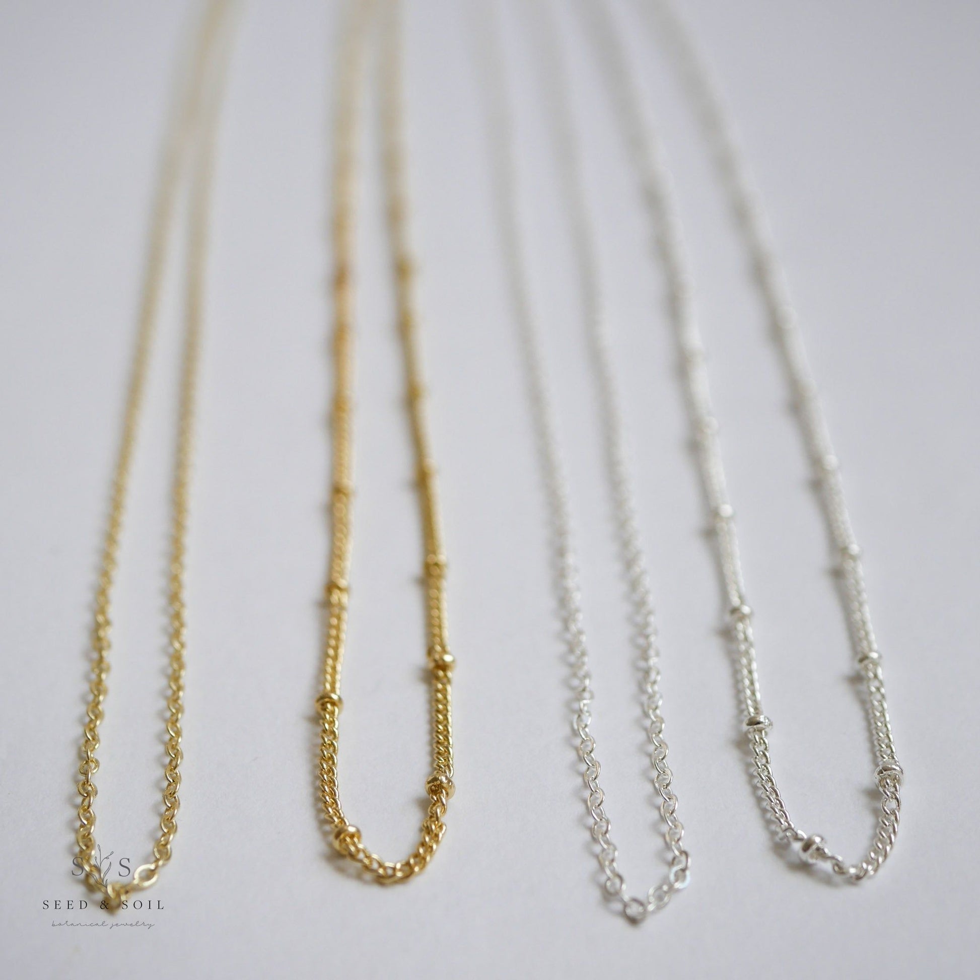 Assorted gold and silver chain options for the Valentine Round Rose Necklace, including 26 and 30 inch hypoallergenic styles.