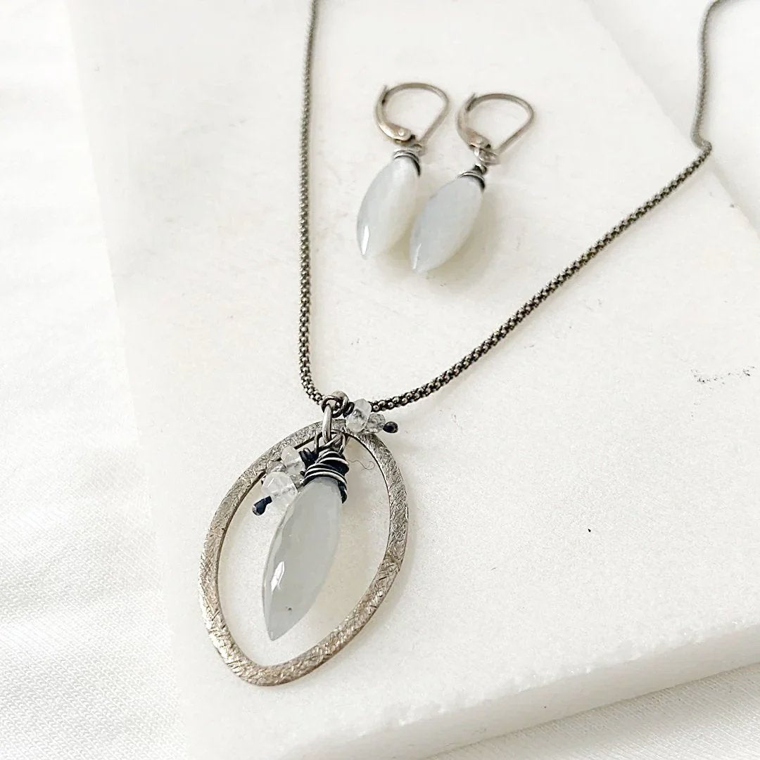 Moonstone Dagger Necklace Set with sterling silver wire-wrapped pendant and matching earrings on white background. Elegant modern jewelry gift.
