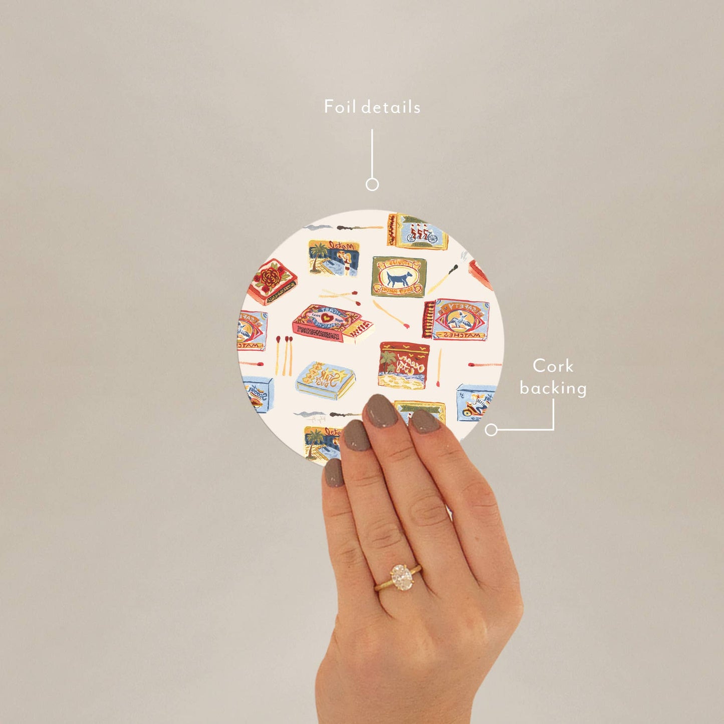 Hand holding Seedlings Coaster by Matchbooks showing foil details and cork backing, ideal for stylish barware protection.