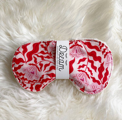 Sweet Dreams Sleep Mask - Red Vine Edition with vibrant red vine pattern on cotton, shown on a fluffy white surface for a cozy, relaxing vibe.