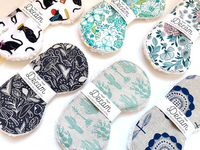 Assorted cotton sleep masks including the Saguaro design with cactus print, perfect for gifting and enhancing sleep quality.