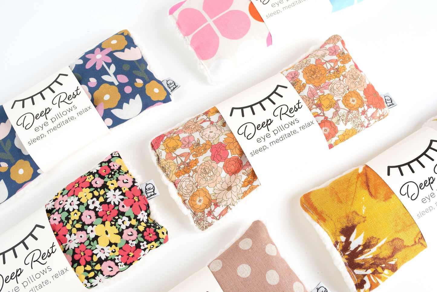 Assorted Liberty Eye Pillows in various colorful patterns, offering weighted stress relief and relaxation for sleep and mindfulness practices.