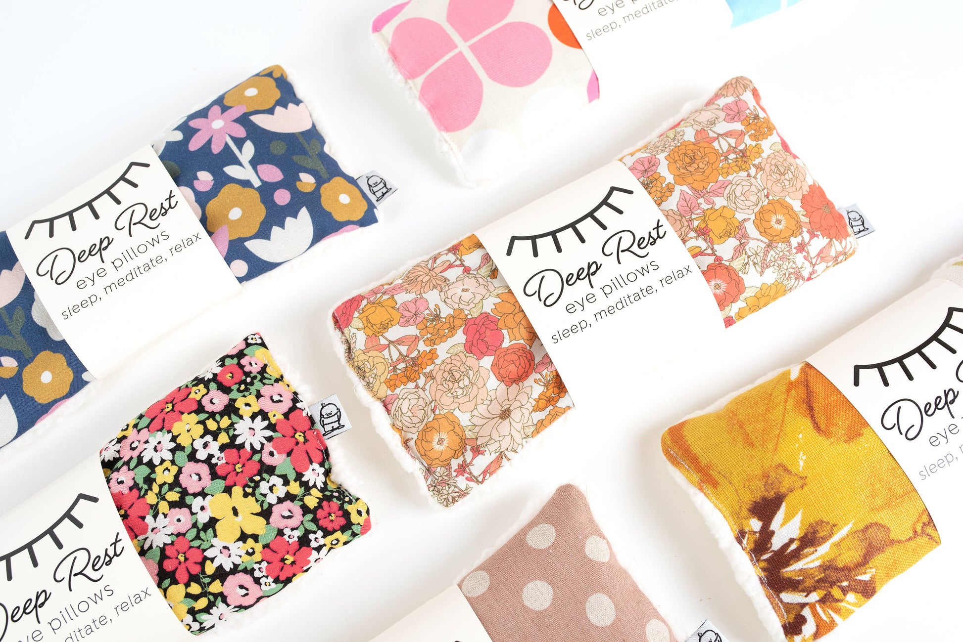 Assorted Liberty Eye Pillows in various colorful patterns, offering weighted stress relief and relaxation for sleep and mindfulness practices.