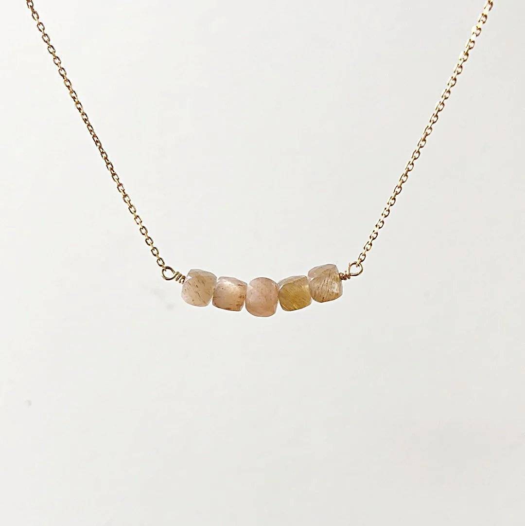 Minimalist gold necklace with five faceted peach moonstone beads on a dainty chain from the Gemstone Gold Earrings Necklace Set.