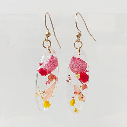 Oval resin earrings with red and yellow real flowers. Elegant floral jewelry from the Pressed Flower Earrings - Real Flowers line.