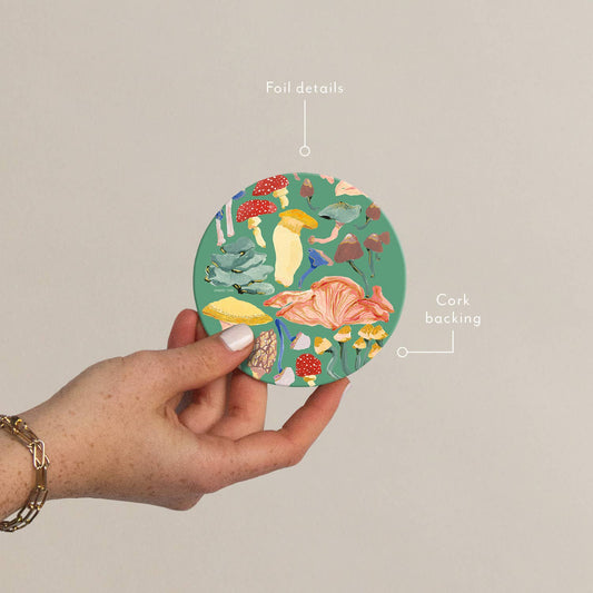 Plantable Shrooms Seedlings Coaster with colorful mushroom illustrations, foil details, and cork backing for heat and water resistance.