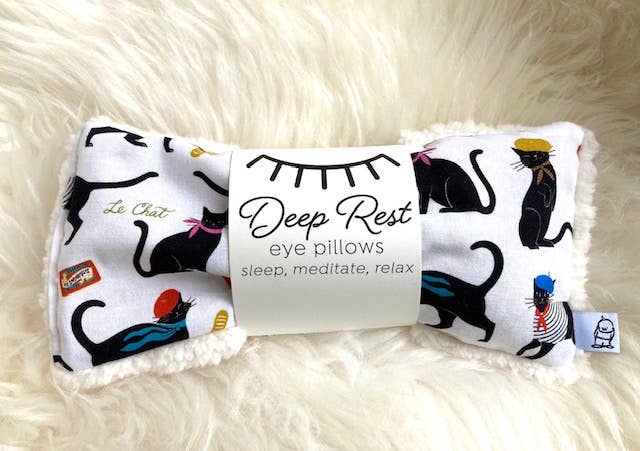 Deep Rest Eye Pillow featuring black cat illustrations on a white background, perfect for meditation, tension relief, and self-care routines.