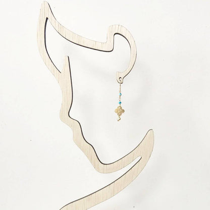 Turquoise chain earrings displayed on a minimalist earring stand, showcasing their lightweight and dainty design for everyday wear.