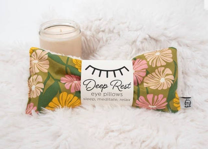 Deep Rest Eye Pillow on fluffy surface beside a candle, ideal for relaxation, stress relief, and meditation routines.