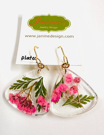 Triangle resin earrings with pink flowers and green leaves and gold hooks. Delicate real flower earrings with a soft, romantic style.
