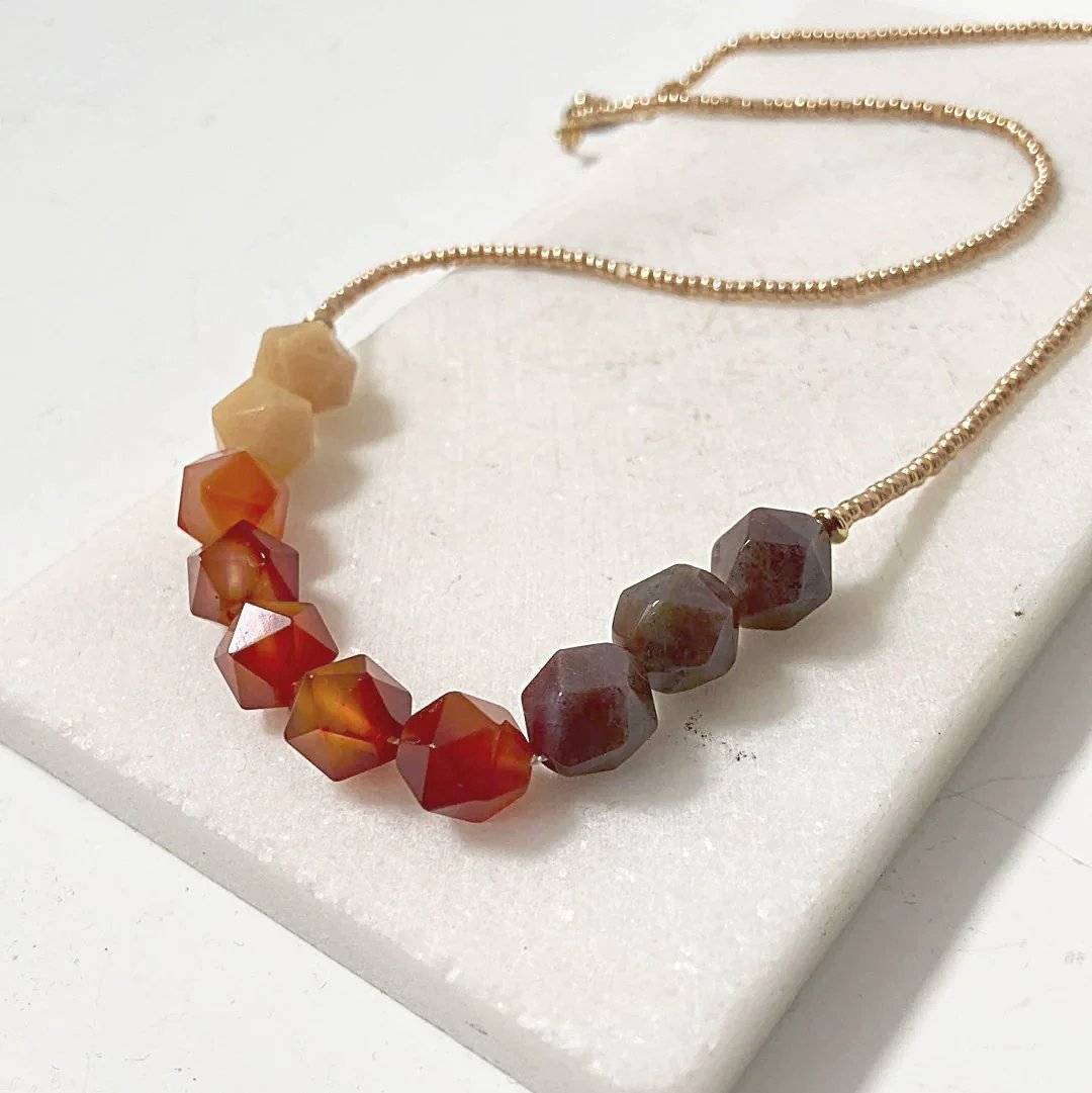Beaded Carnelian Necklace - Uni-T Design featuring faceted carnelian beads in gradient tones with gold glass seed beads and brass clasp.