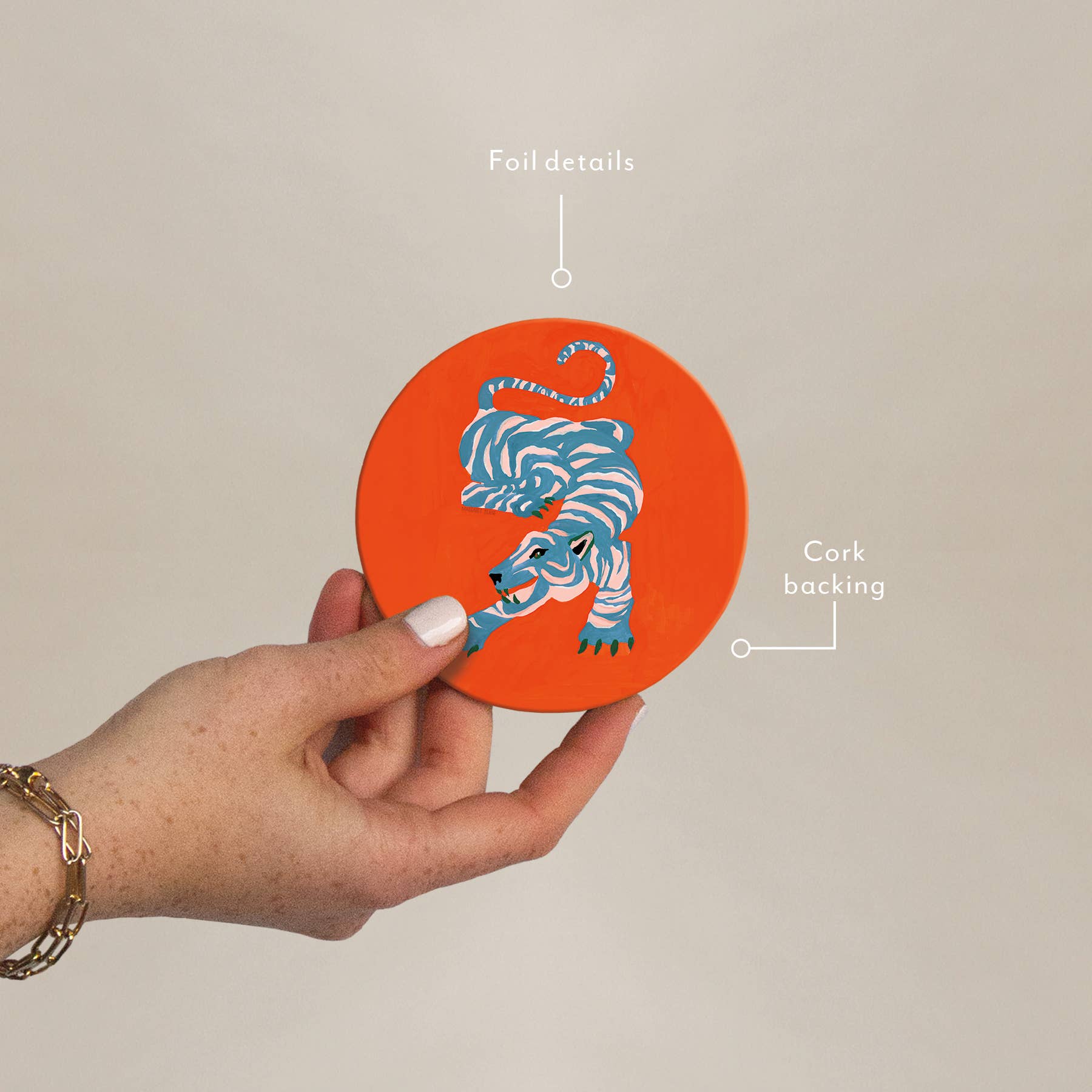 Hand holding Wild Thang Cork Coaster showing foil details and cork backing, part of eco-friendly barware collection for stylish gifting.