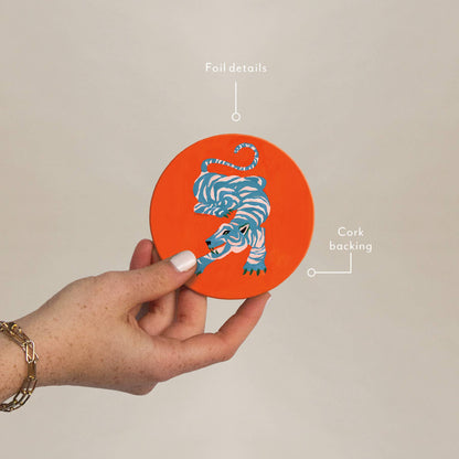 Hand holding Wild Thang Cork Coaster showing foil details and cork backing, part of eco-friendly barware collection for stylish gifting.