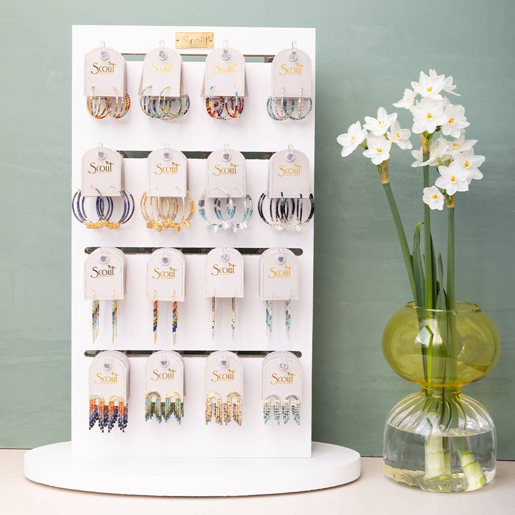 Retail display of Scout jewelry featuring Miyuki Thread Earrings - Dark Multi Gold among other styles, ideal for boutique or gift shop settings.