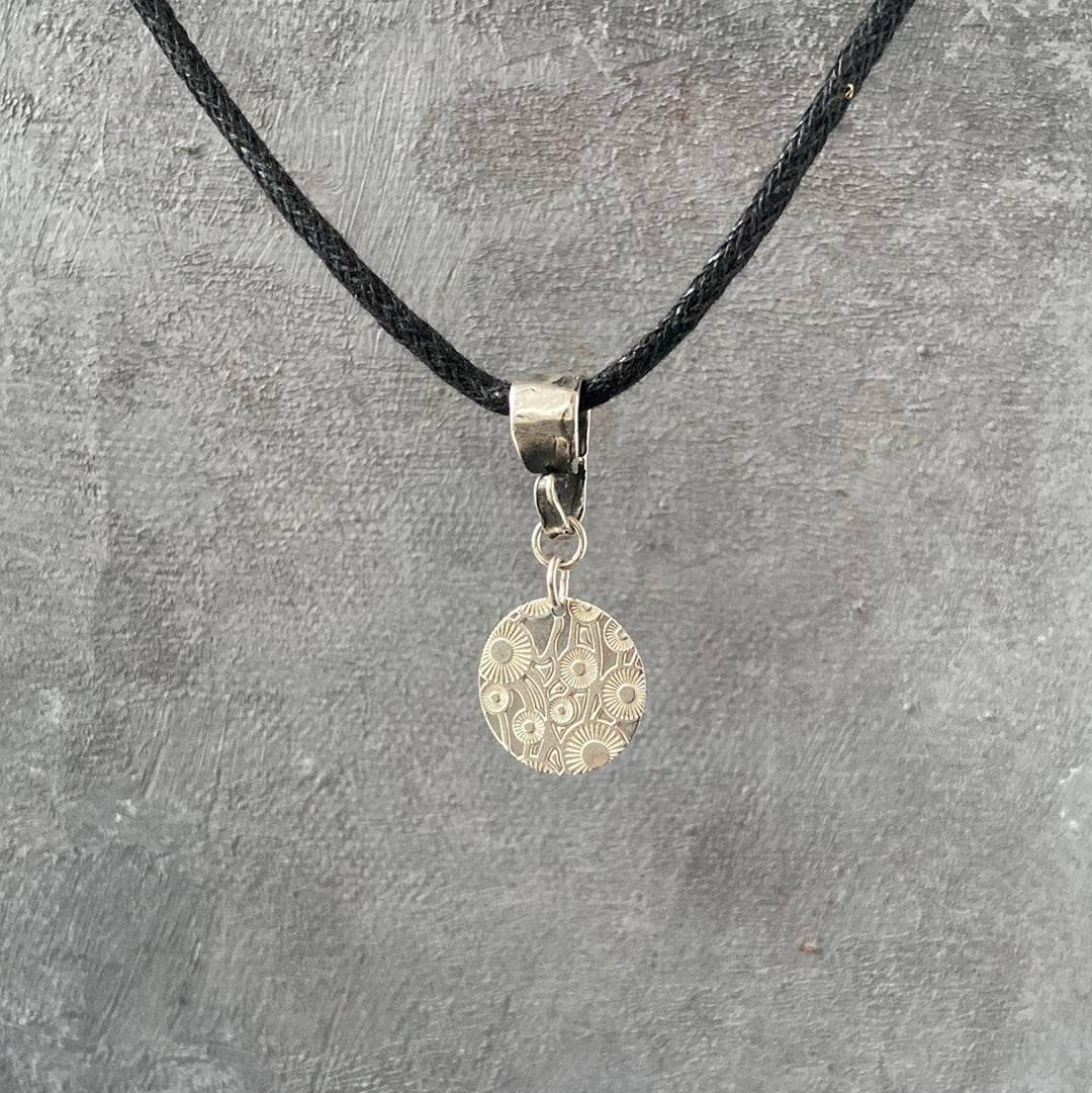 Sterling Silver Dandelion Medallion Necklace by Uni-T displayed on textured background, highlighting detailed floral engraving and minimalist charm.