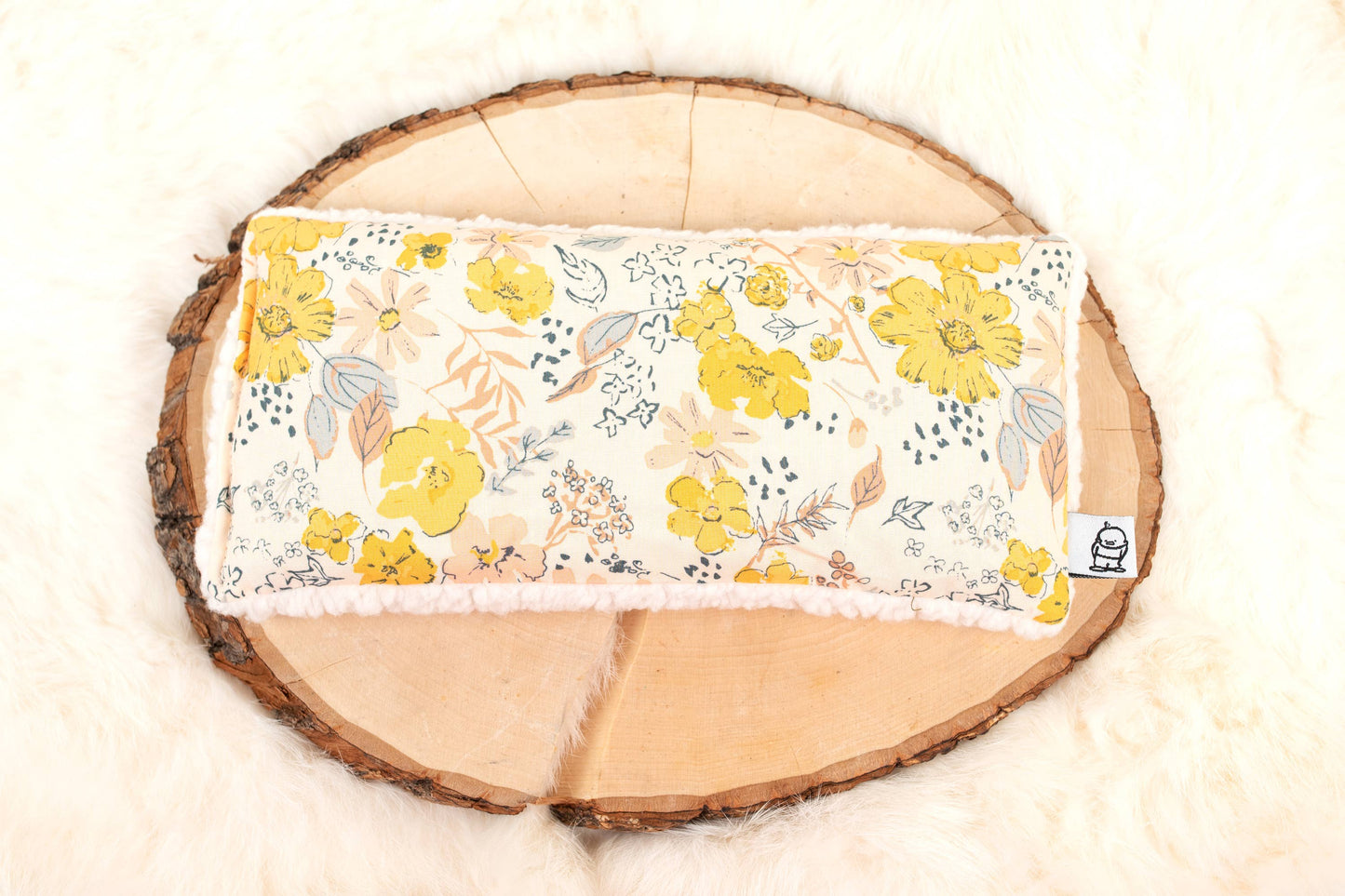 Floral Deep Rest Eye Pillow - Relaxation & Sleep Aid placed on wood slice and fur, perfect for soothing anxiety and enhancing sleep.