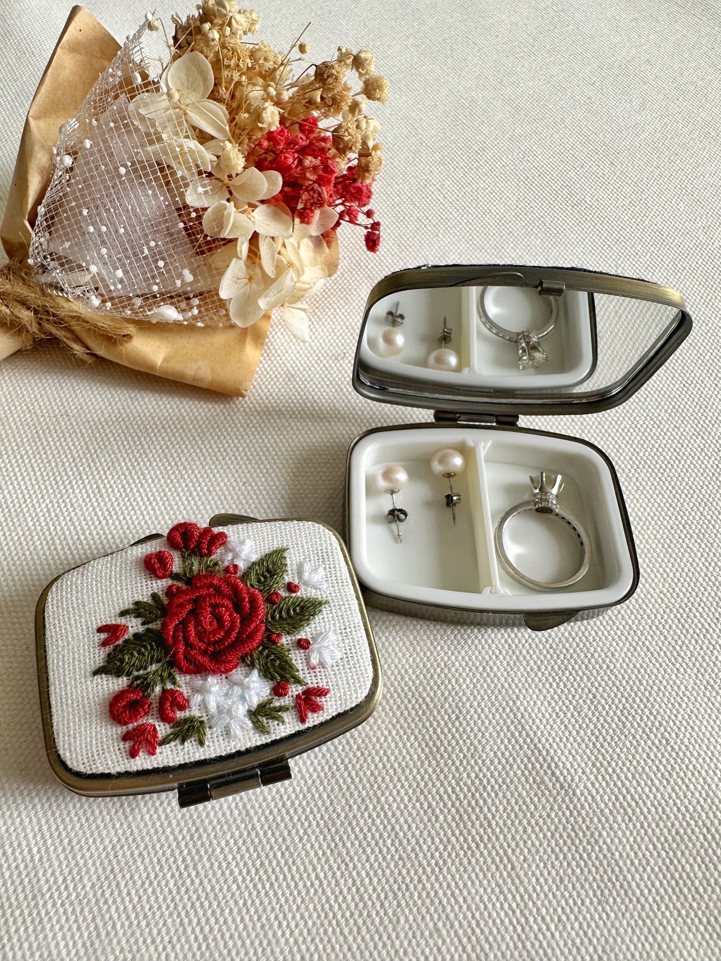 White Floral Embroidered Jewelry Box - Elegant Storage with red rose design, open to display mirror and jewelry compartments beside a dried bouquet.