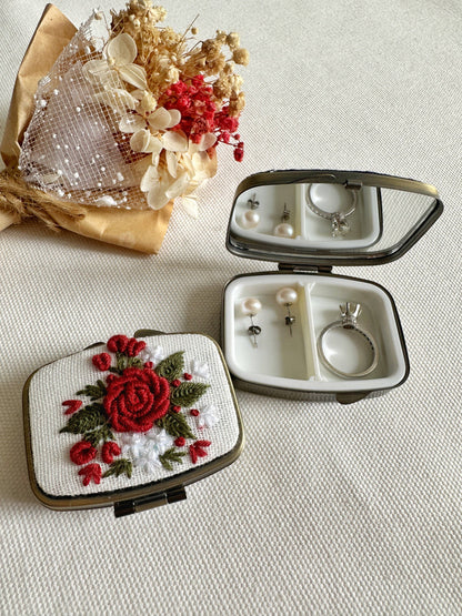 White Floral Embroidered Jewelry Box - Elegant Storage with red rose design, open to display mirror and jewelry compartments beside a dried bouquet.
