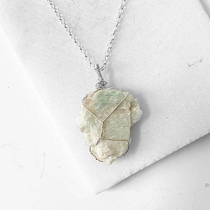 Sterling silver chain necklace featuring a wire wrapped Amazonite stone, showcasing raw crystal texture and soothing tones for gemstone lovers.