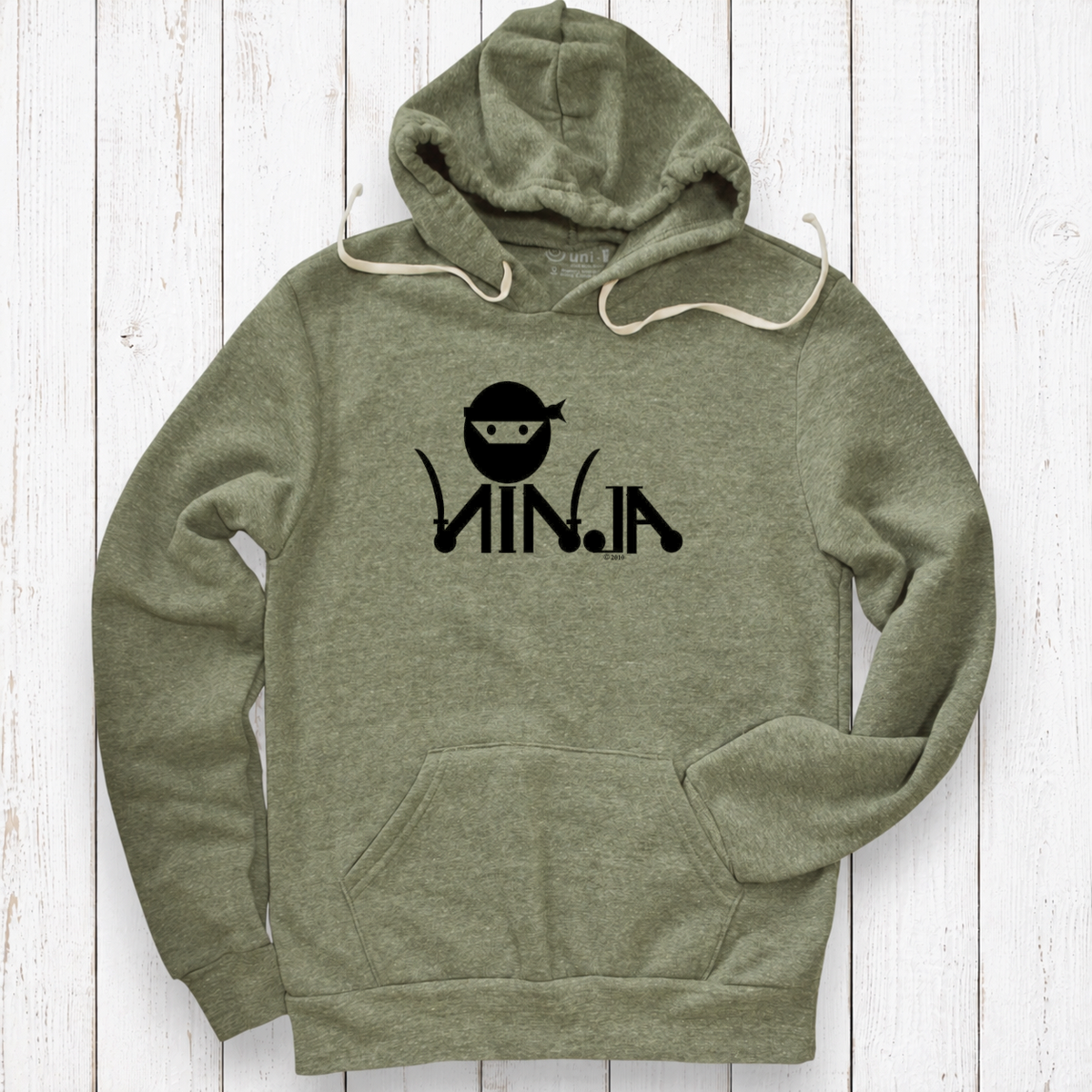 Heather olive hoodie on white wood.png