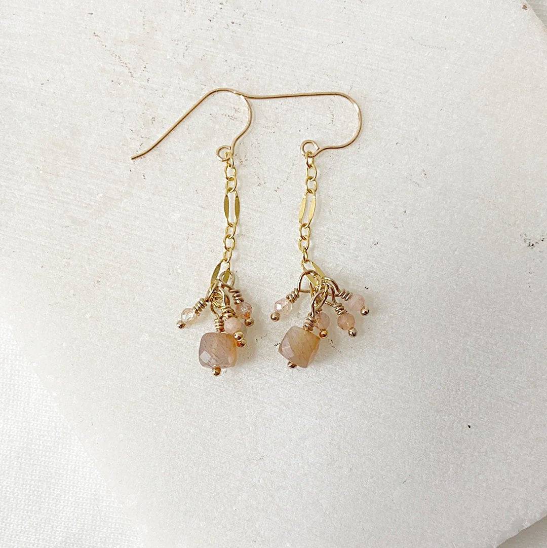 Close-up of Gemstone Gold Drop Earrings with peach moonstone and delicate gold chain, part of the Dainty Gemstone Jewelry Set.