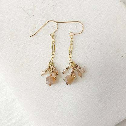 Close-up of Gemstone Gold Drop Earrings with peach moonstone and delicate gold chain, part of the Dainty Gemstone Jewelry Set.