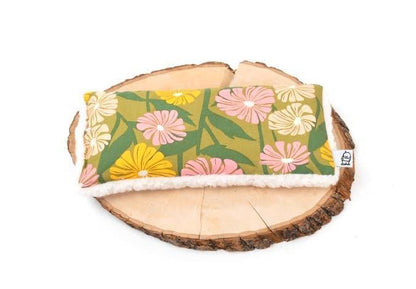 Deep Rest Eye Pillow with floral cotton fabric and sherpa backing displayed on a wooden slab, perfect for home wellness use.