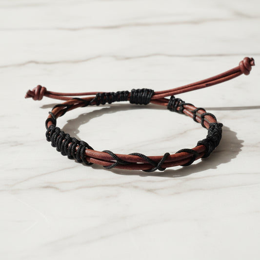 Leather bracelet with black cord accents