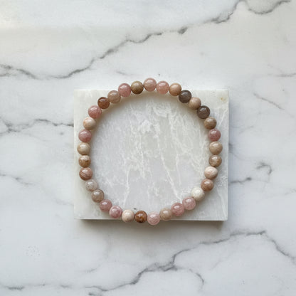 Beaded gemstone bracelet on white marble slab