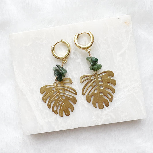 Gold monstera leaf earrings with turquoise stones
