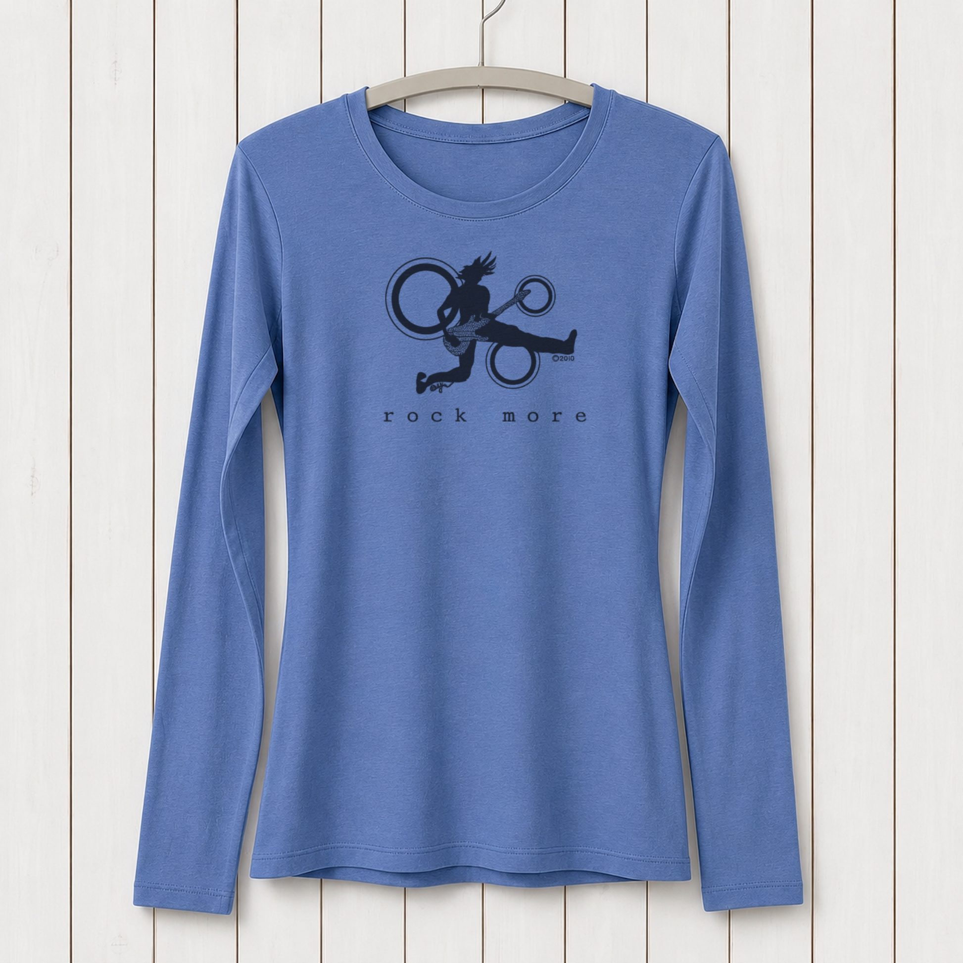 Blue long sleeve graphic T-shirt for women featuring a black silhouette of a guitarist with circular design elements, made from bamboo and organic cotton, displayed on a hanger against a white wooden background, SKU: WLSXSNAV